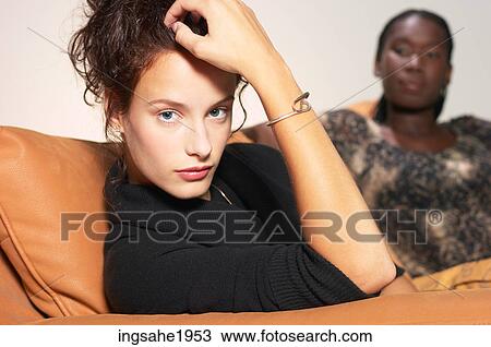 Stock Image - Close-up of woman on chair BE 1. Fotosearch
