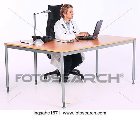 Stock Image - doctor at desk BE 1. Fotosearch