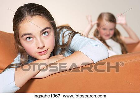 Girl resting on sofa BE View Large Photo Image Stock Photo - Girl resting on sofa BE. Fotosearch