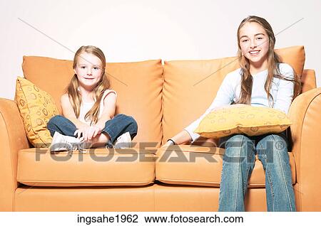 Girls sitting on sofa BE 6 View Large Photo Image Stock Image - Girls sitting on sofa BE 6. Fotosearch