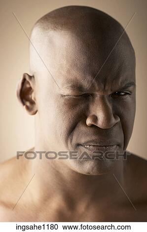 Stock Image - Grimacing man's face. Fotosearch