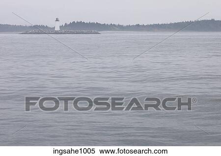 Lighthouse along misty shore View Large Photo Image Stock Photography - Lighthouse along misty shore. Fotosearch