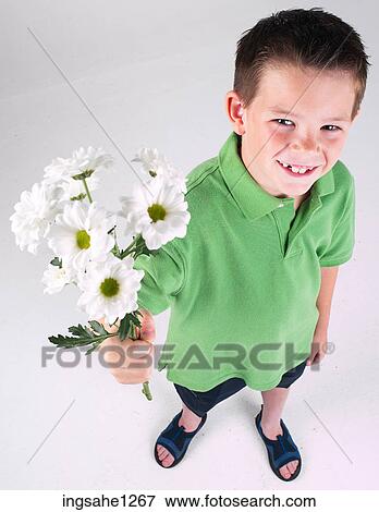 Little boy holding flowers View Large Photo Image Stock Photo - Little boy holding flowers . Fotosearch
