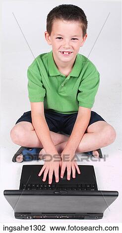 Stock Image - Little boy using laptop . Fotosearch