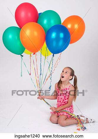 Little girl holding balloons View Large Photo Image Stock Image - Little girl holding balloons . Fotosearch