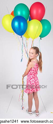 Stock Image - Little girl holding balloons . Fotosearch