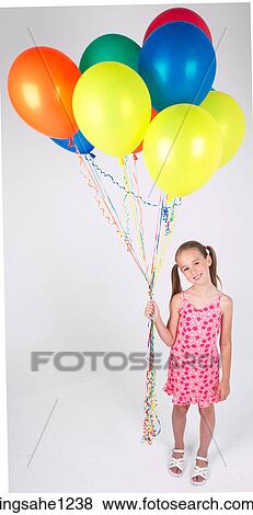 Stock Photo - Little girl holding balloons . Fotosearch