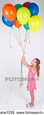 Stock Photo - Little girl holding balloons . Fotosearch