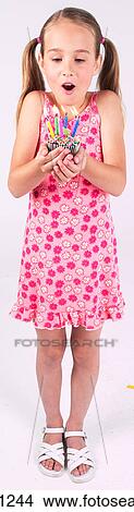 Little girl holding birthday cupcake View Large Photo Image Picture - Little girl holding birthday cupcake . Fotosearch