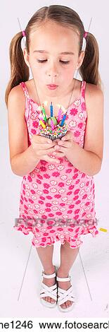 Little girl holding birthday cupcake View Large Photo Image Stock Photograph - Little girl holding birthday cupcake . Fotosearch