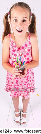 Little girl holding birthday cupcake View Large Photo Image Stock Photography - Little girl holding birthday cupcake . Fotosearch