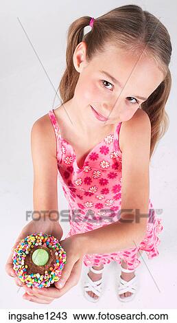 Little girl holding cupcake View Large Photo Image Stock Image - Little girl holding cupcake . Fotosearch