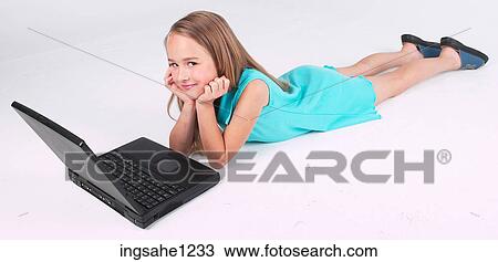 Stock Image - Little girl using laptop . Fotosearch