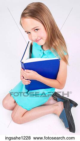 Little girl with blue book View Large Photo Image Stock Photo - Little girl with blue book . Fotosearch