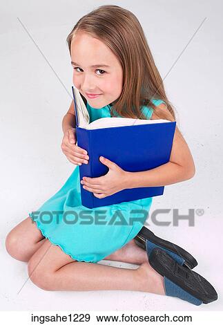 Little girl with blue book View Large Photo Image Stock Photo - Little girl with blue book . Fotosearch