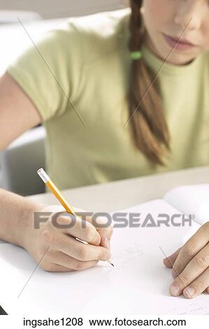 Stock Photo - Little girl writing at her desk 6. Fotosearch
