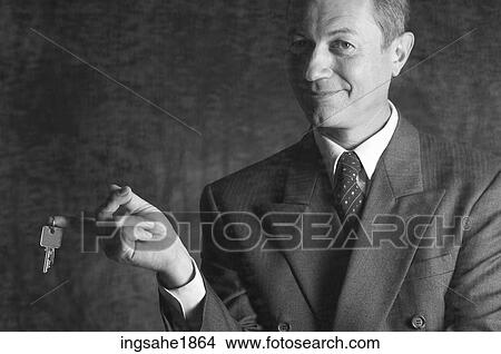 Picture - Man extending keys BE. Fotosearch