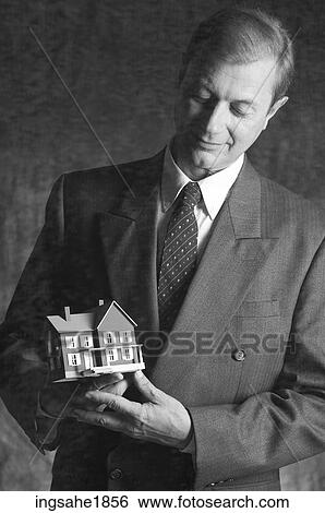 Man holding model house BE 1 View Large Photo Image Stock Photograph - Man holding model house BE 1. Fotosearch