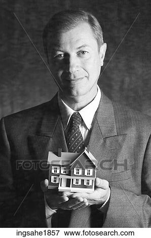 Man holding model house BE 5 View Large Photo Image Stock Photo - Man holding model house BE 5. Fotosearch