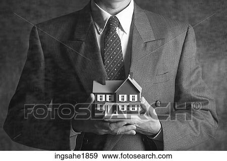 Man holding model house BE 9 View Large Photo Image Stock Photo - Man holding model house BE 9. Fotosearch