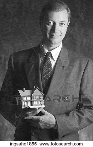 Man holding model house BE View Large Photo Image Stock Photography - Man holding model house BE. Fotosearch