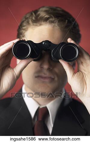 Man in suit holding binoculars View Large Photo Image Stock Photograph - Man in suit holding binoculars. Fotosearch