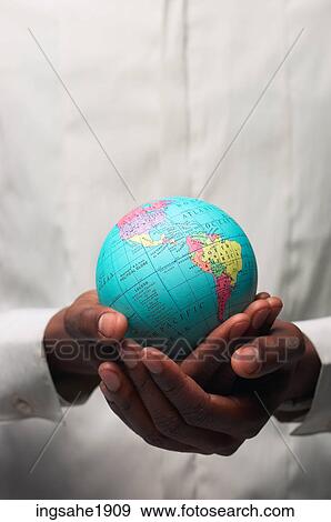 Man in white shirt holding globe BE 2 View Large Photo Image Stock Photo - Man in white shirt holding globe BE 2. Fotosearch