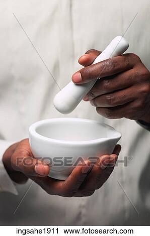 Man in white shirt holding mortar and pestle BE View Large Photo Image Stock Image - Man in white shirt holding mortar and pestle BE. Fotosearch