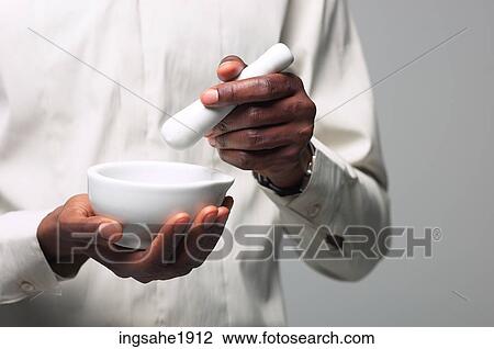 Man in white shirt holding mortar and pestle BE 2 View Large Photo Image Stock Image - Man in white shirt holding mortar and pestle BE 2. Fotosearch