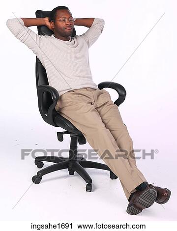 Stock Image - man relaxing in chair BE. Fotosearch