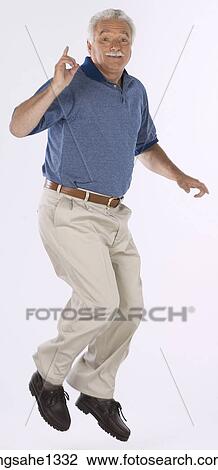 Stock Image - man standing with blue shirt . Fotosearch