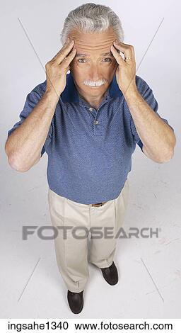 Stock Image - man standing with blue shirt . Fotosearch