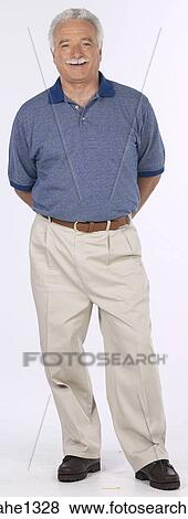 man standing with blue shirt View Large Photo Image Stock Photo - man standing with blue shirt . Fotosearch