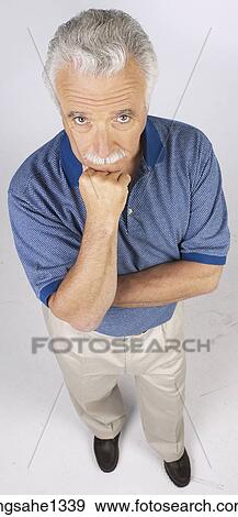 Stock Photo - man standing with blue shirt . Fotosearch