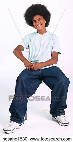 Man with afro sitting on stool a82 View Large Photo Image Stock Image - Man with afro sitting on stool a82. Fotosearch