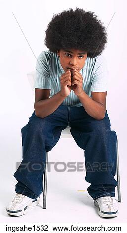 Man with afro slouching on stool a81 View Large Photo Image Stock Image - Man with afro slouching on stool a81. Fotosearch