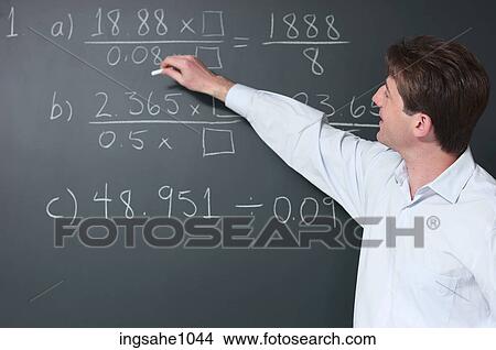 Picture - Math teacher at blackboard. Fotosearch