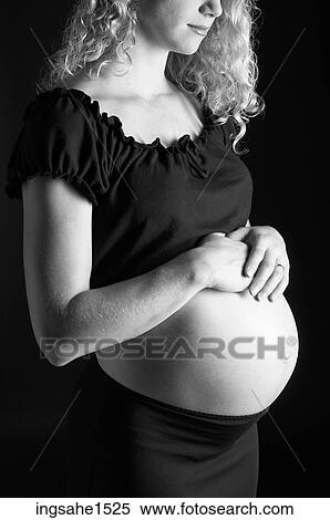 Pregnant woman holding belly View Large Photo Image Stock Photography - Pregnant woman holding belly . Fotosearch