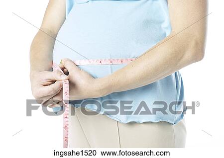 Pregnant woman measuring belly View Large Photo Image Stock Image - Pregnant woman measuring belly. Fotosearch