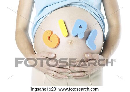 Stock Image - Pregnant woman with ""girl"" spelled out on stomach. Fotosearch