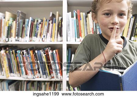 Quiet little boy reading library book View Large Photo Image Stock Photo - Quiet little boy reading library book. Fotosearch