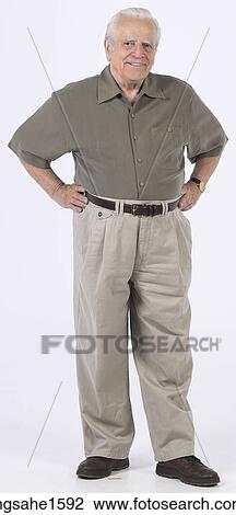 senior standing with hands on hips View Large Photo Image Stock Image - senior standing with hands on hips . Fotosearch