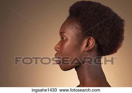 Stock Image - Side profile of woman with exposed neck. Fotosearch
