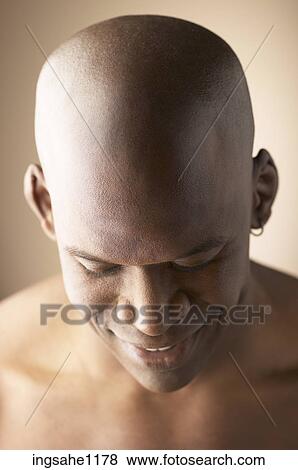 Smiling man looking downwards View Large Photo Image Stock Photo - Smiling man looking downwards. Fotosearch