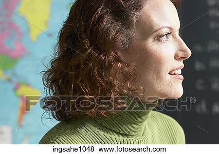 Smiling teacher with map and blackboard in background View Large Photo Image Stock Photo - Smiling teacher with map and blackboard in background. Fotosearch