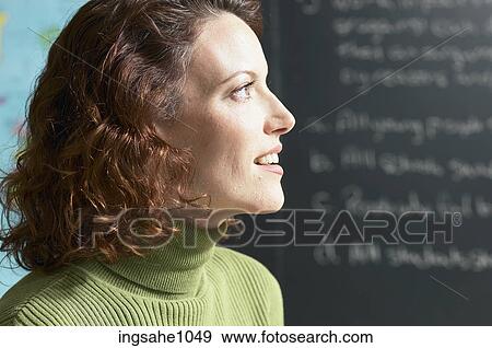 Smiling teacher with map and blackboard in background 1 View Large Photo Image Stock Photo - Smiling teacher with map and blackboard in background 1. Fotosearch