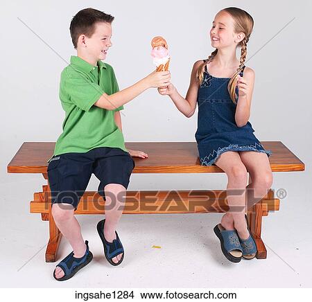Two children eating ice cream View Large Photo Image Picture - Two children eating ice cream . Fotosearch