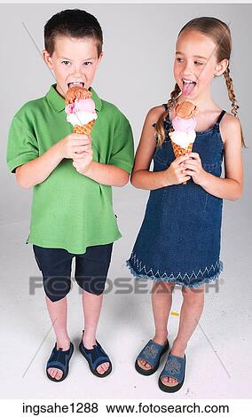 Two children eating ice cream View Large Photo Image Stock Photo - Two children eating ice cream . Fotosearch