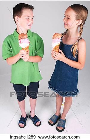 Two children eating ice cream View Large Photo Image Stock Photo - Two children eating ice cream . Fotosearch