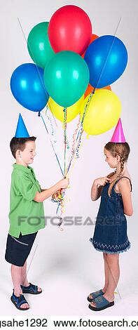 Two children holding balloons View Large Photo Image Stock Image - Two children holding balloons . Fotosearch